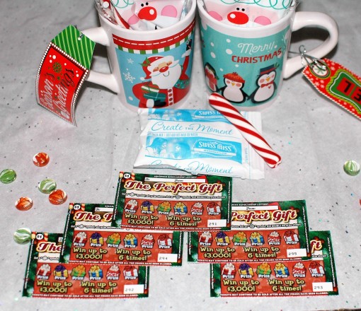 Need a fun and practical stocking stuffer idea? Put together a cute little treat bag of hot cocoa and peppermint sticks and place it in a festive coffee mug. Add in a few scratch-off tickets ad you're good to go! #GiveInstantJoy